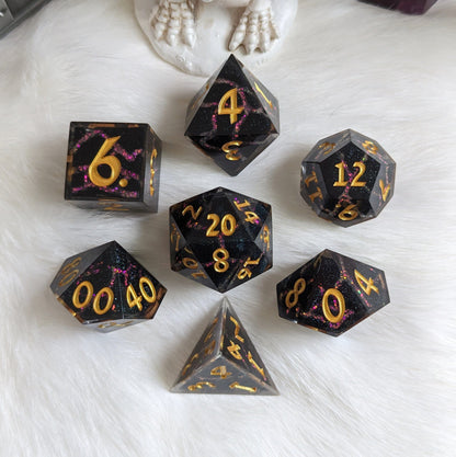 Black and red lightning resin DnD dice set with sharp edges and cracked lightning design in glittering red on a white surface.