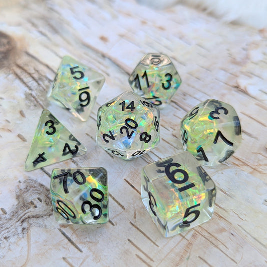 Solar Blade TTRPG Dice Set with iridescent rainbow effects on wooden tabletop.