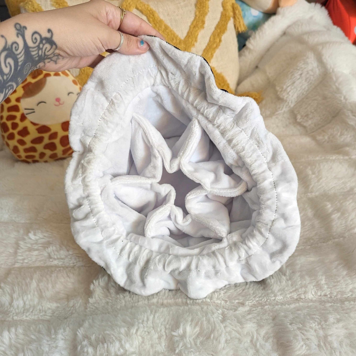 Interior view of multi-pocket dice bag with soft white plush fabric lining, showcasing the spacious and organized compartments.