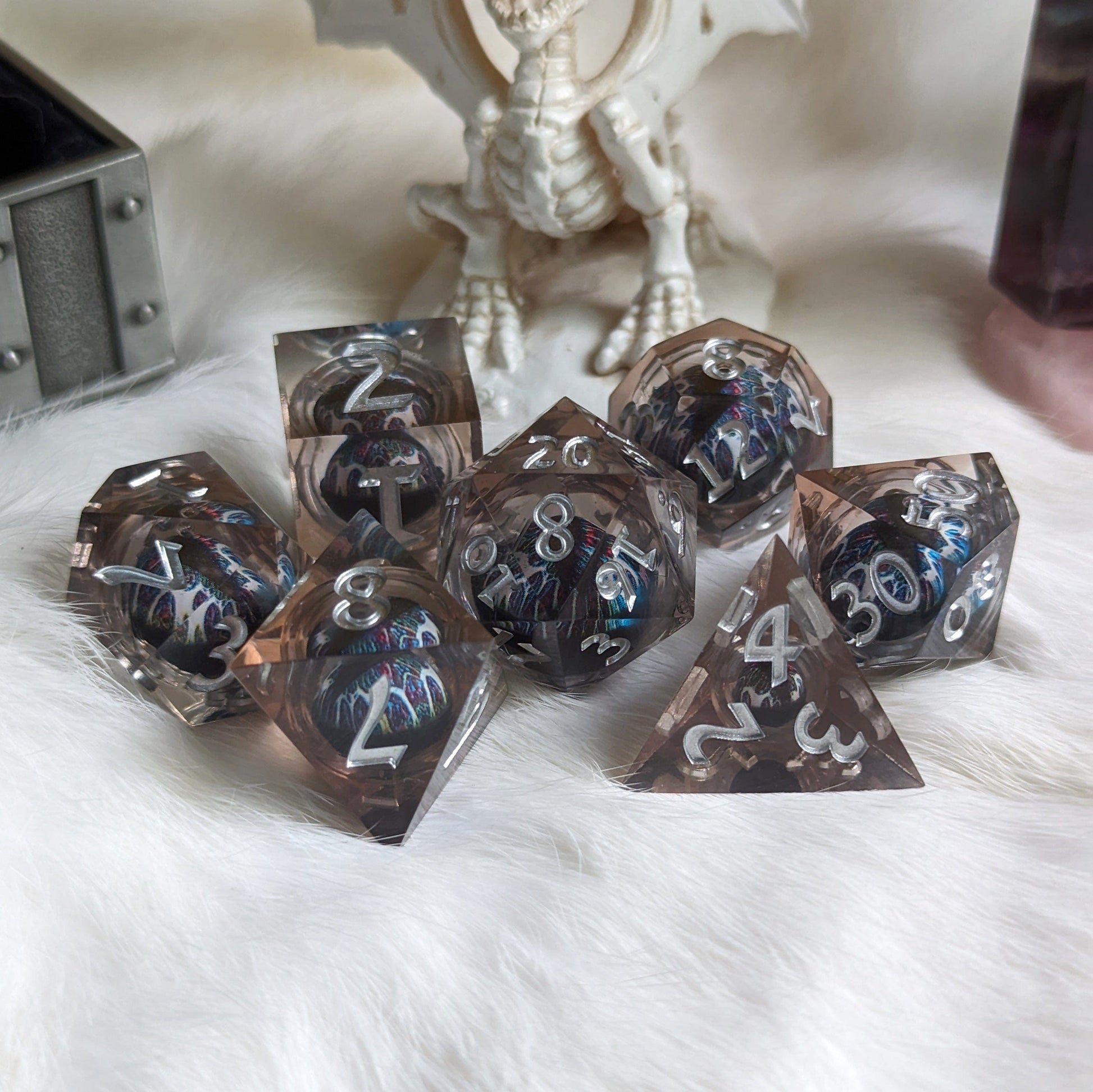 Technicolor Moving Eye Liquid Core Dice Set with swirling colors on a tabletop, adding magic to tabletop adventures.