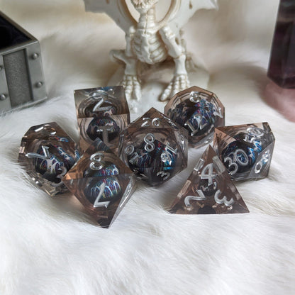 Technicolor Moving Eye Liquid Core Dice Set with swirling colors on a tabletop, adding magic to tabletop adventures.