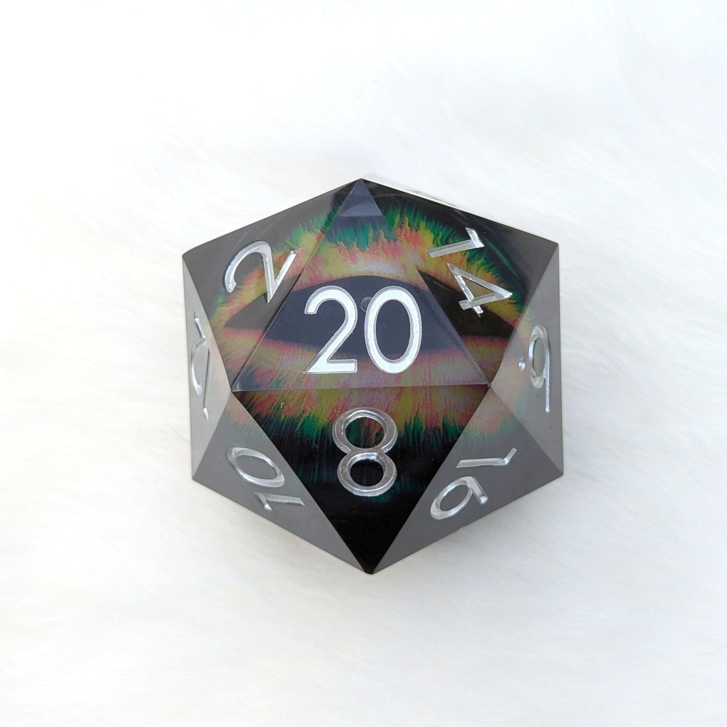 The Infernal Watcher Giant D20 with mystical eye design, black-tinted resin, and vibrant liquid core against a light background.