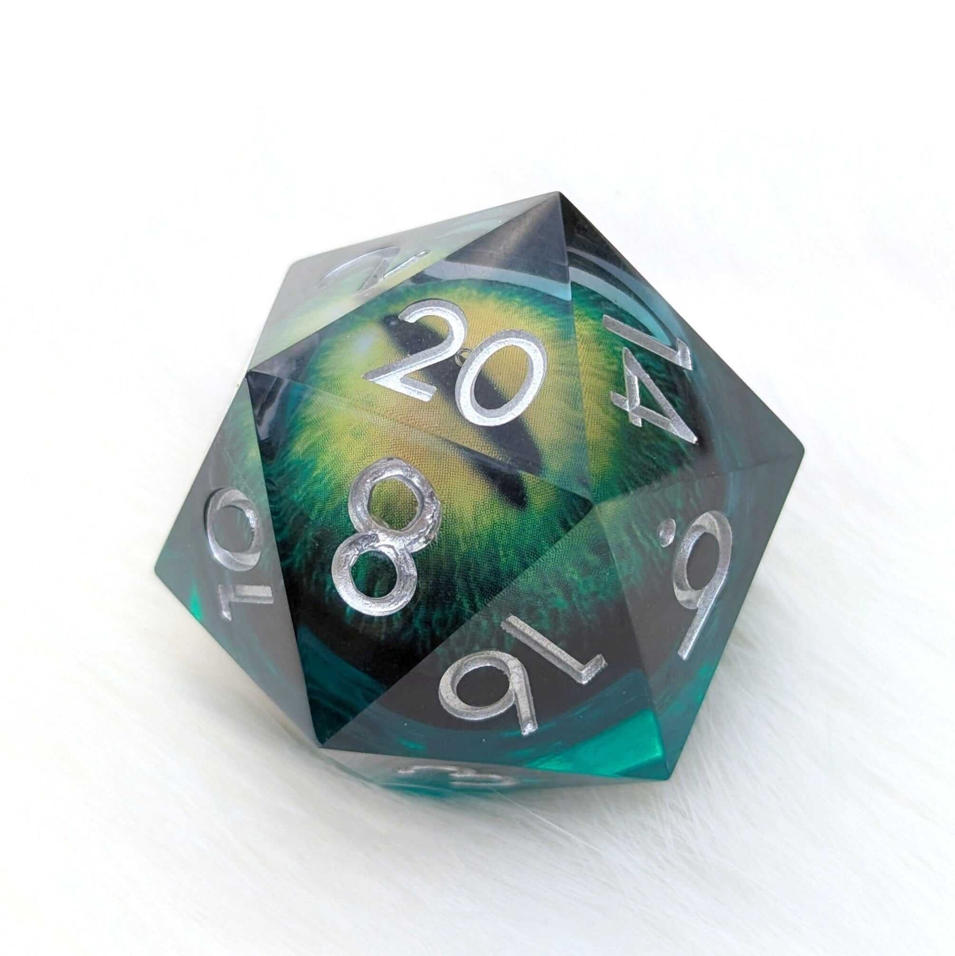 Oversized green D20 die with liquid core and vivid eye, The Watchful Eye.