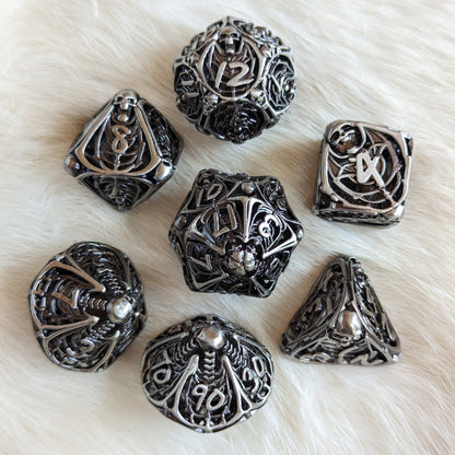 Vampire Skeleton Hollow Metal Dice Set - 7 Piece Gothic Polyhedral Dice for TTRPGs on Faux Fur Background