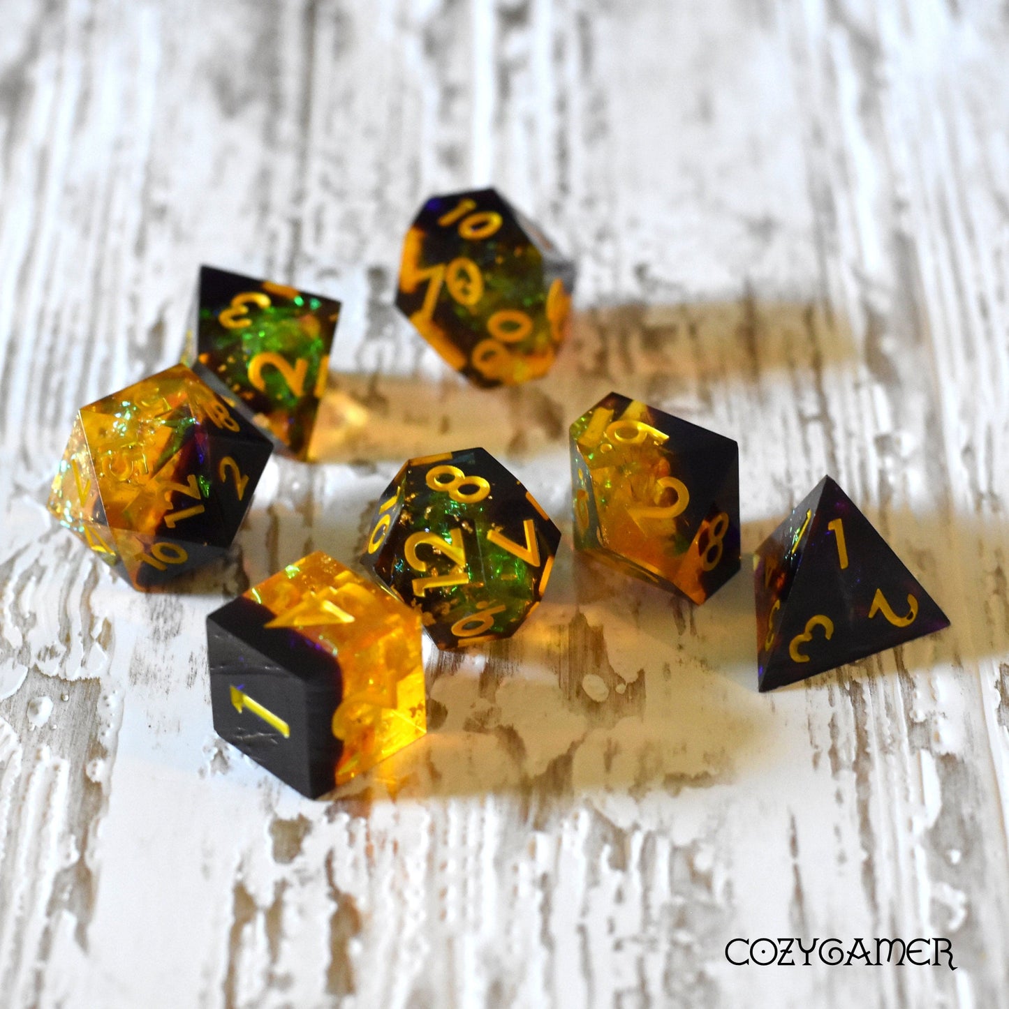 Autumn Magic Sharp Edge Resin Dice Set with black and yellow layers and glitter, 7-piece polyhedral DND dice for TTRPGs.