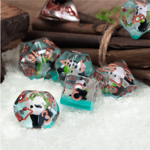 Bamboo Panda Resin Dice Set with cute panda and bamboo leaf designs, 7-piece polyhedral TTRPG dice for DND games on textured surface.