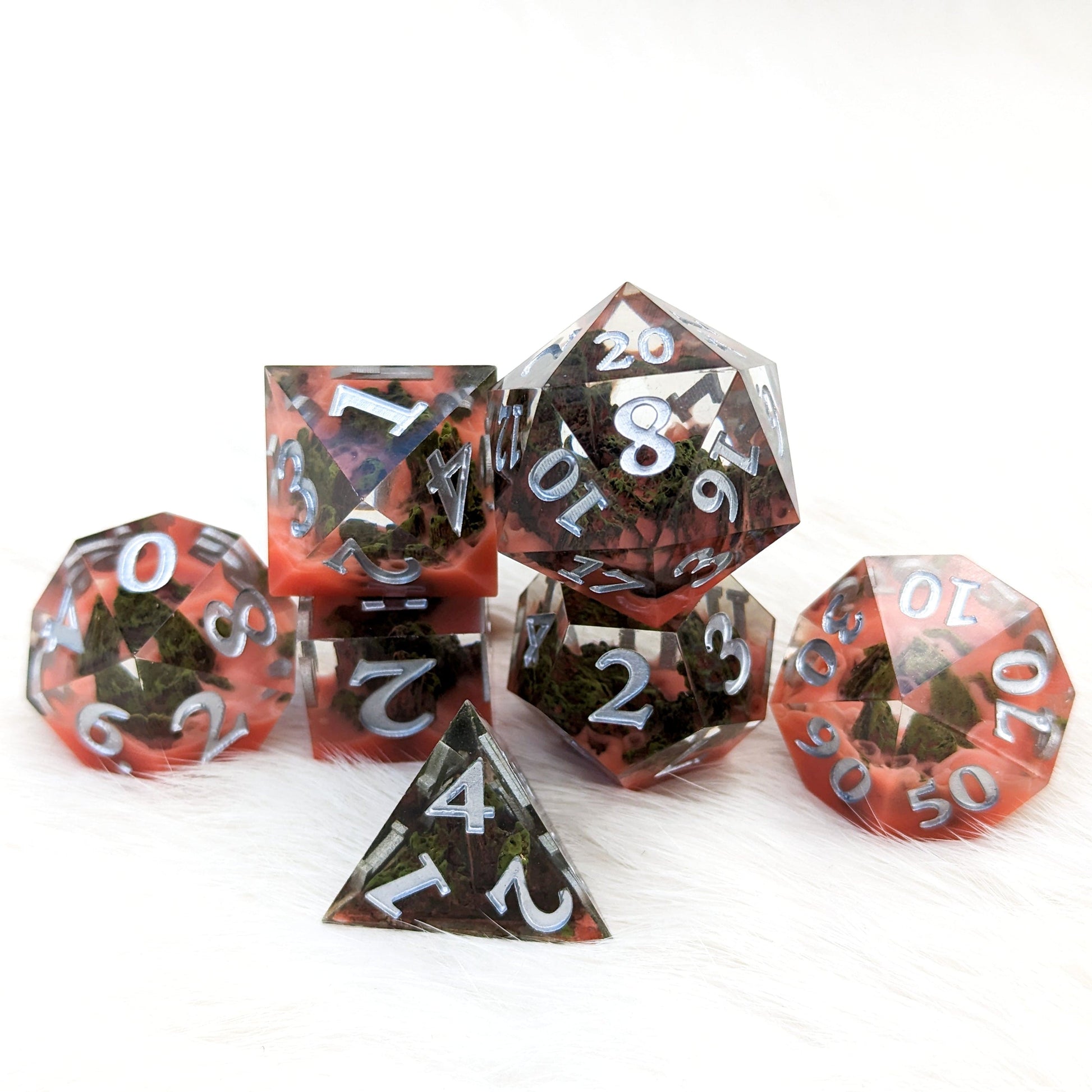 Blood Mountain Sharp Edge Resin DnD Dice Set with stone forested mountains and red misty clouds, 7-piece polyhedral set for RPG games.