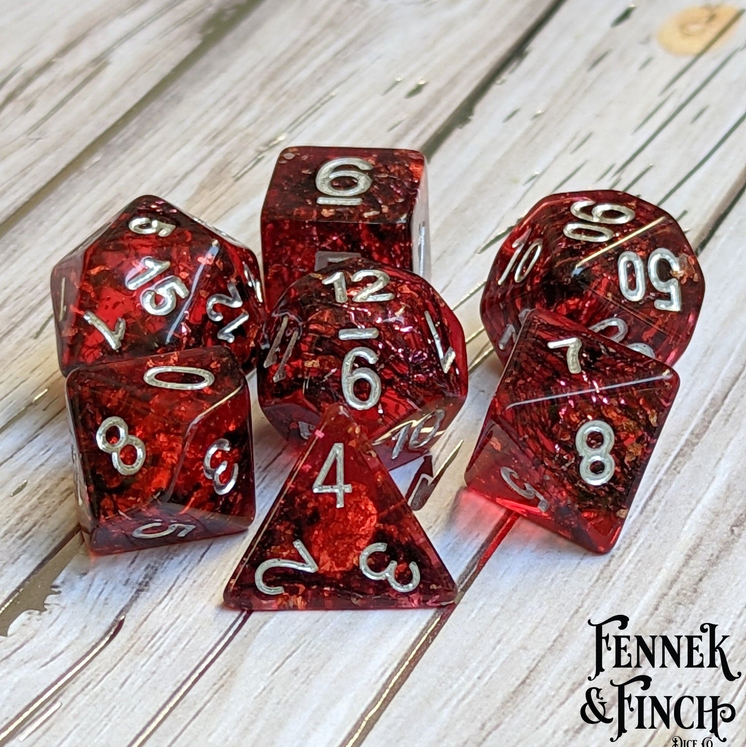 Blood Skies Dice Set, 7-piece dark forest-themed dice with tiny bats, placed on a rustic wooden surface.