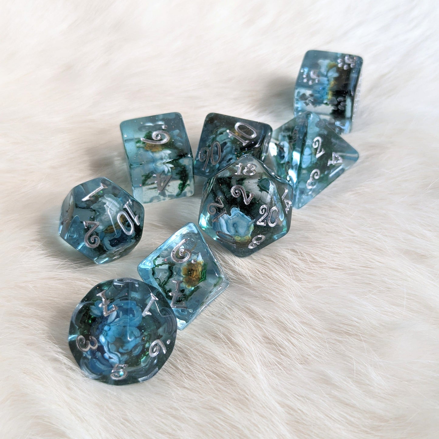 Blue flower and moss polyhedral dice set with real flowers and glittering resin on a fur background, includes exclusive Fennek and Finch D6.