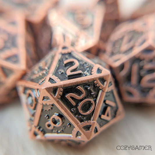 Copper metal gear dice set for tabletop RPGs, featuring intricate clockwork design and included seven polyhedral pieces.