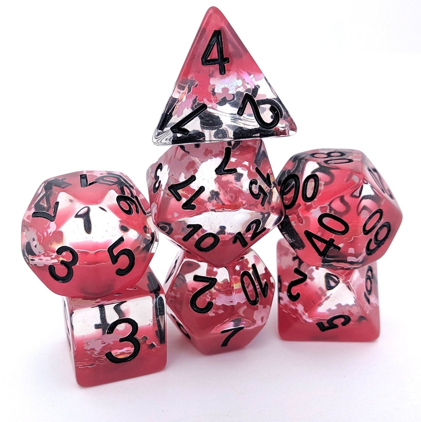 Red translucent glitter DnD dice set with black numbers, featuring puzzle piece glitters, includes 7 polyhedral dice for tabletop RPGs.