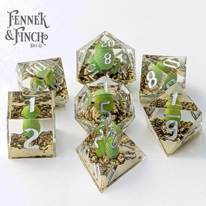 Dragon Egg Sharp Edge Resin Dice Set with green dragon eggs, 7 piece polyhedral DND dice, displayed in front of Fennek & Finch logo.