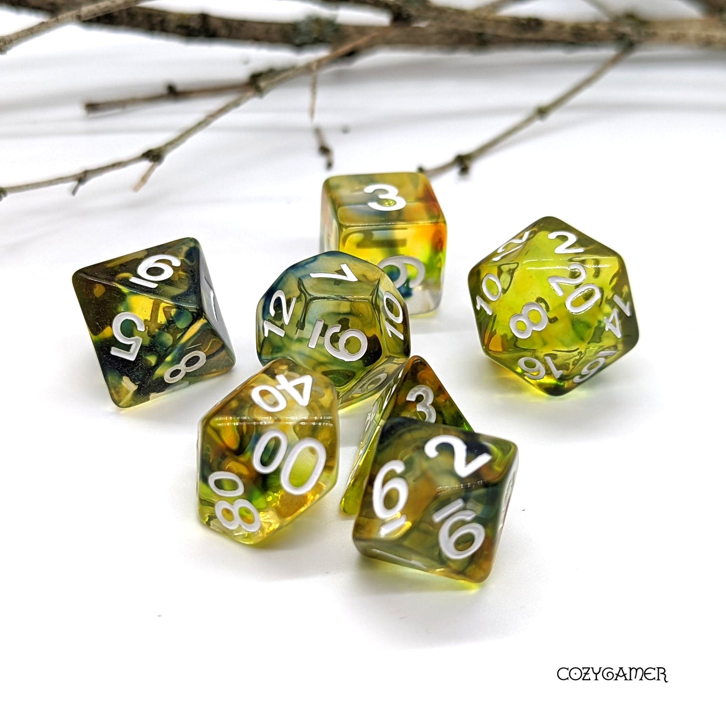 Earthen Caster Dice Set with green swirling ink, 7 polyhedral dice for tabletop RPGs like DnD, featuring clear resin design.