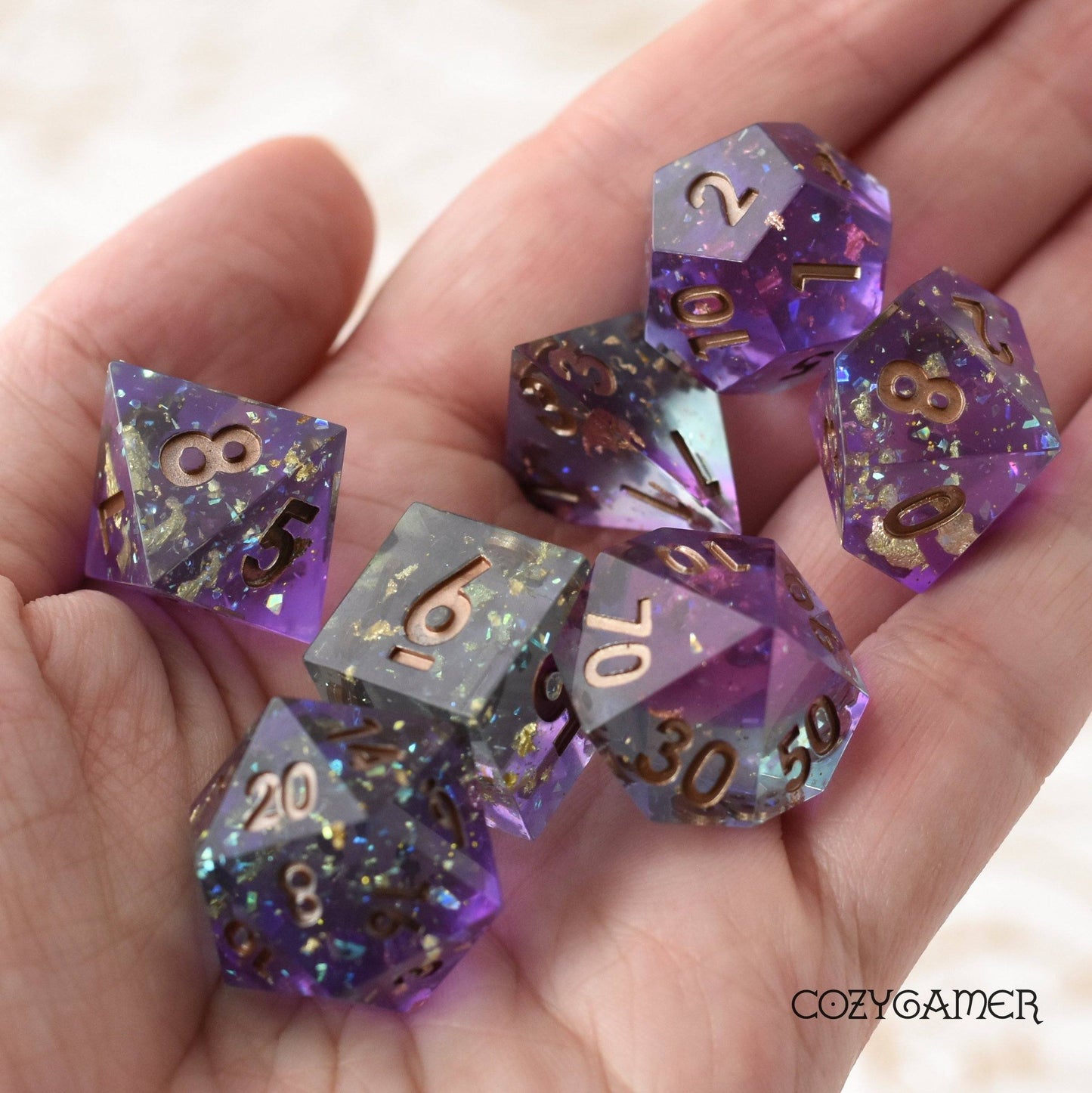 Enchanter's Tower Sharp Edge Dice Set. Layered Purple and Blue Clear resin with copper foil and opal flakes