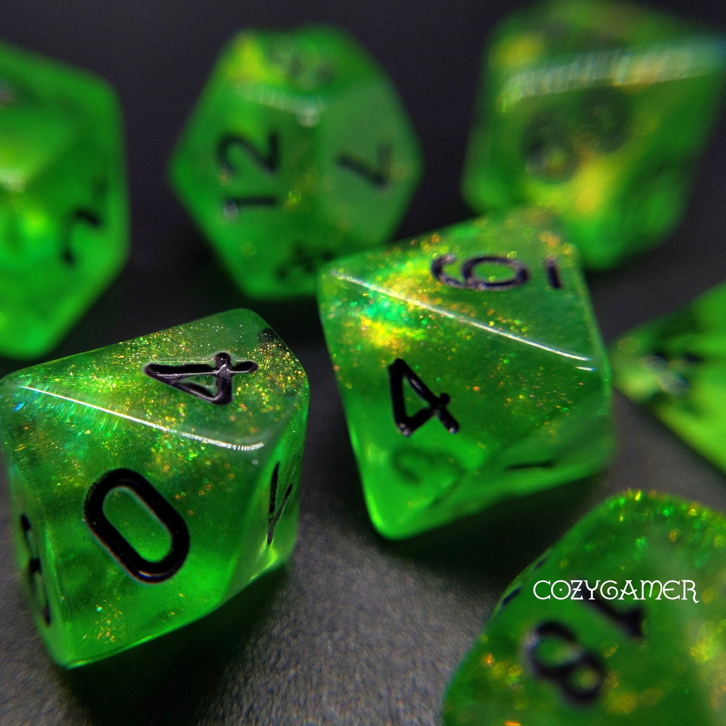 Forest Green Will O Wisp glitter dice set for TTRPG, DnD, includes polyhedral dice with black font on shimmering green acrylic.