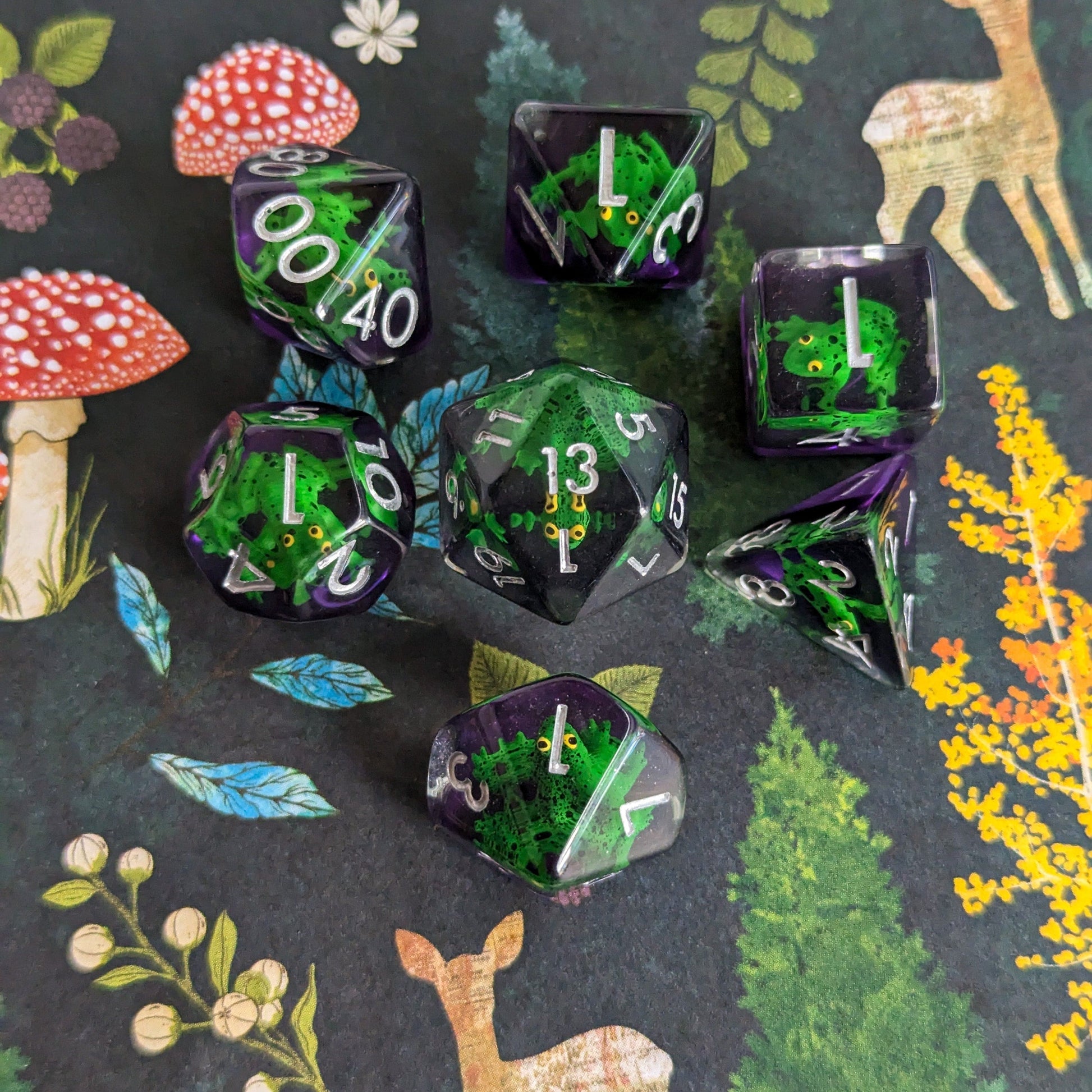 Hoppy Hauntings Frog DnD Dice Set with green frogs and clear purple design on a woodland-themed background.