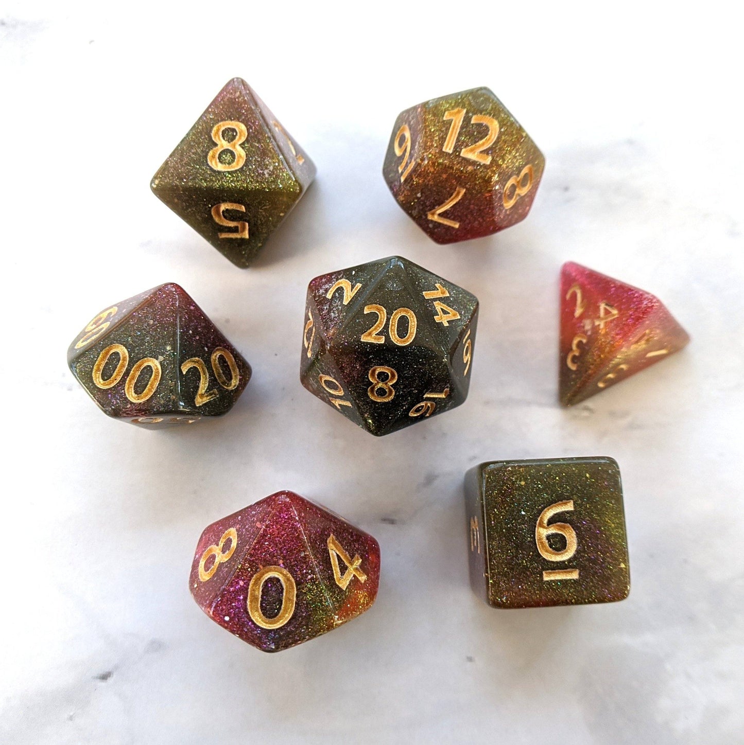 Galaxy Rose Dice Set with pink and green marbled shimmer, 7 polyhedral pieces for Dungeons and Dragons and Magic The Gathering.