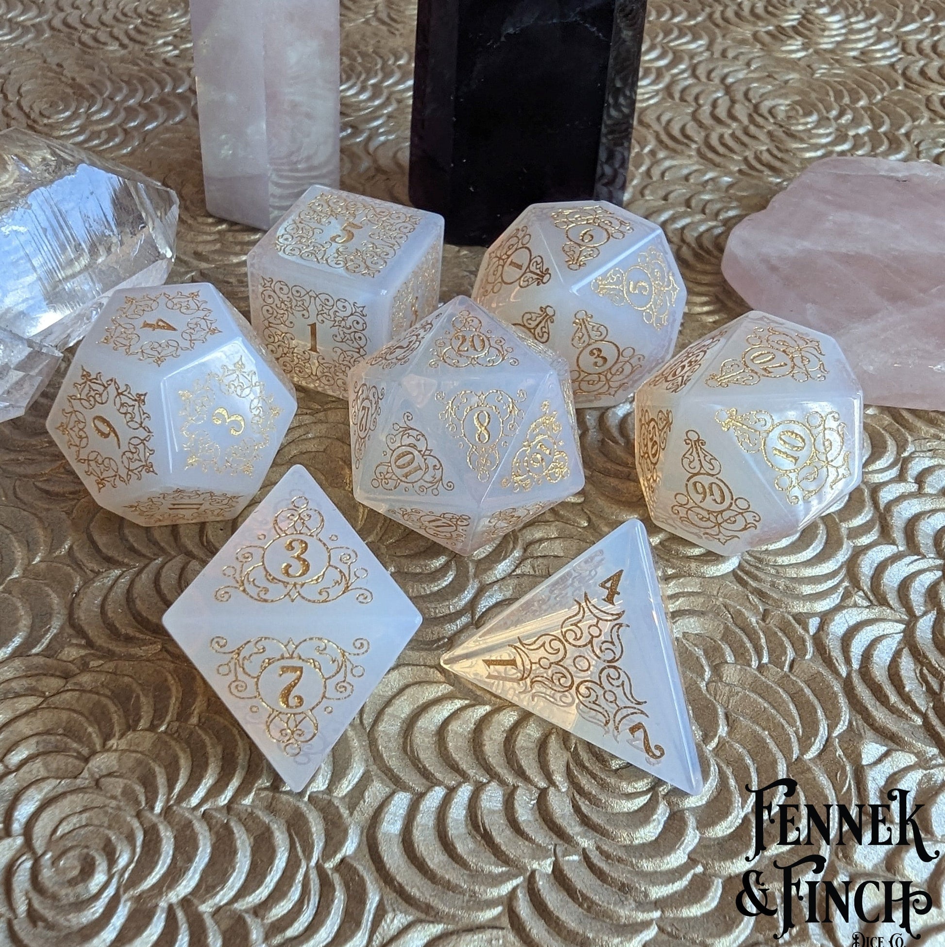 Garden Gate opalite gemstone dice set with intricate gold floral patterns on a decorative swirled background.