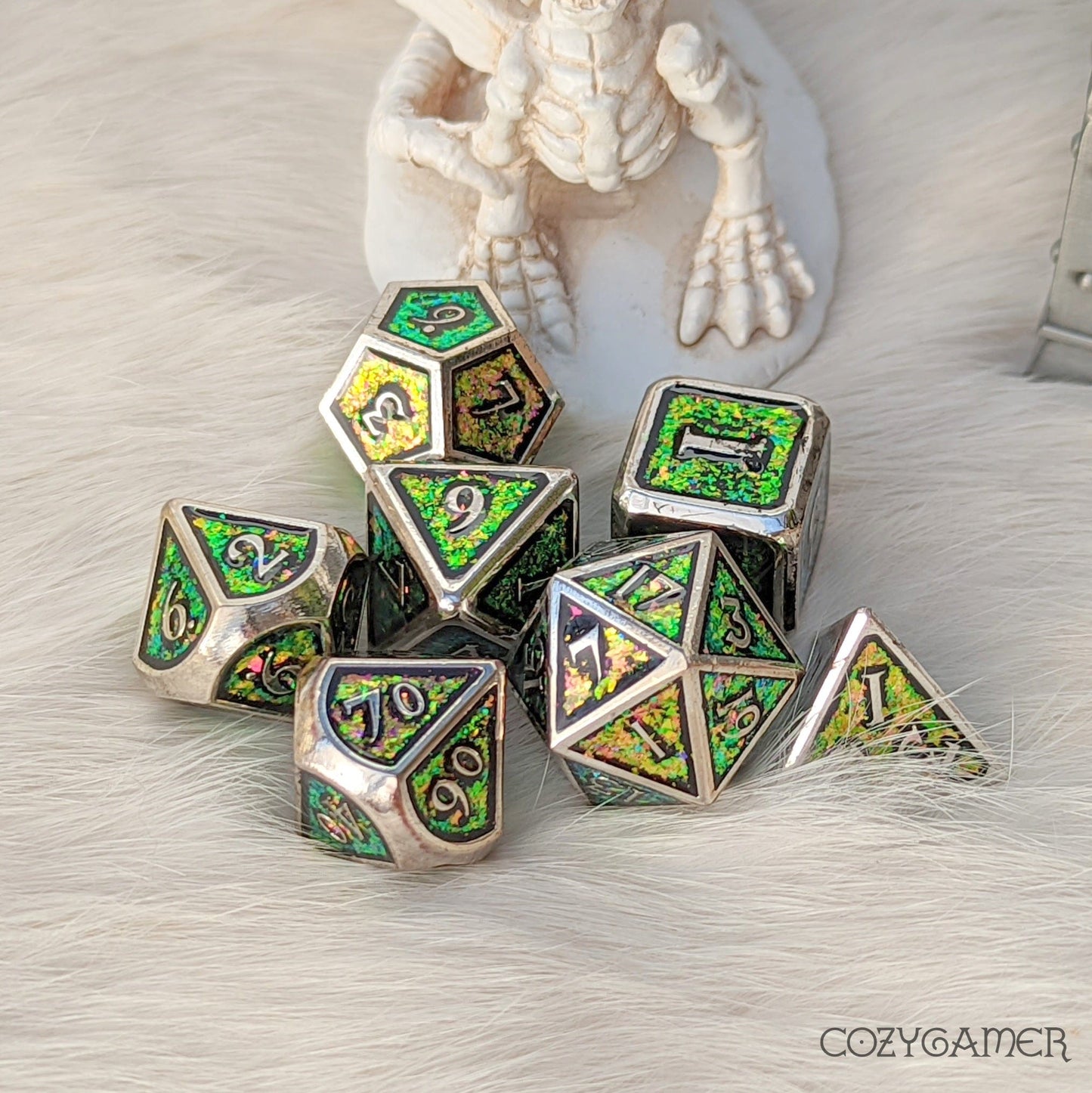 Green and pink color shifting glitter metal dice set with silver trim for tabletop RPGs like Dungeons and Dragons.