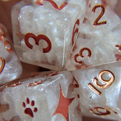 Holy Nexus 8 Piece Dice Set. Clear resin with pearly white clouds, glitter, and copper font.