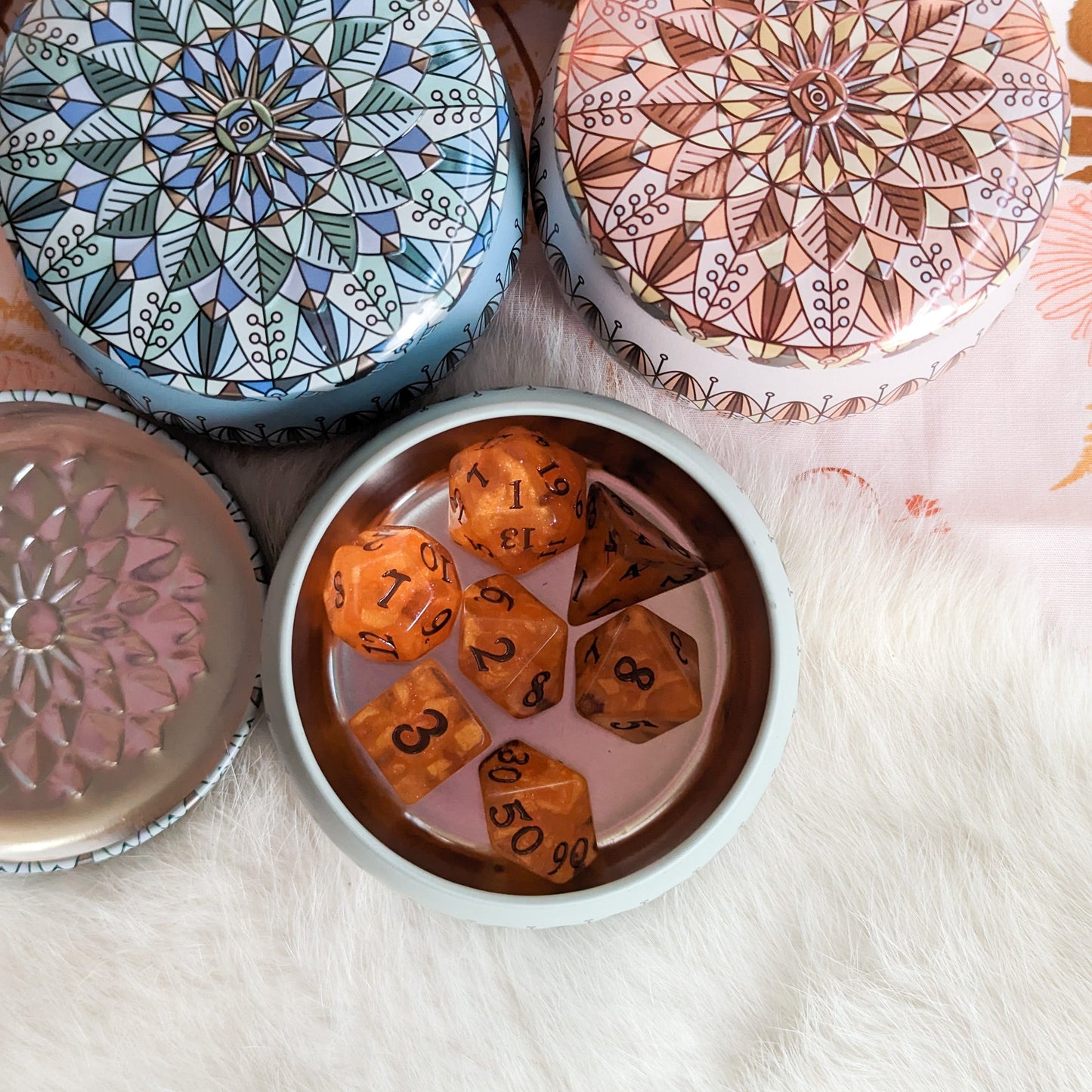 Leaf Mandala Dice Box with colorful design, open to reveal orange dice set, perfect for travel storage of up to 21 dice and a miniature.