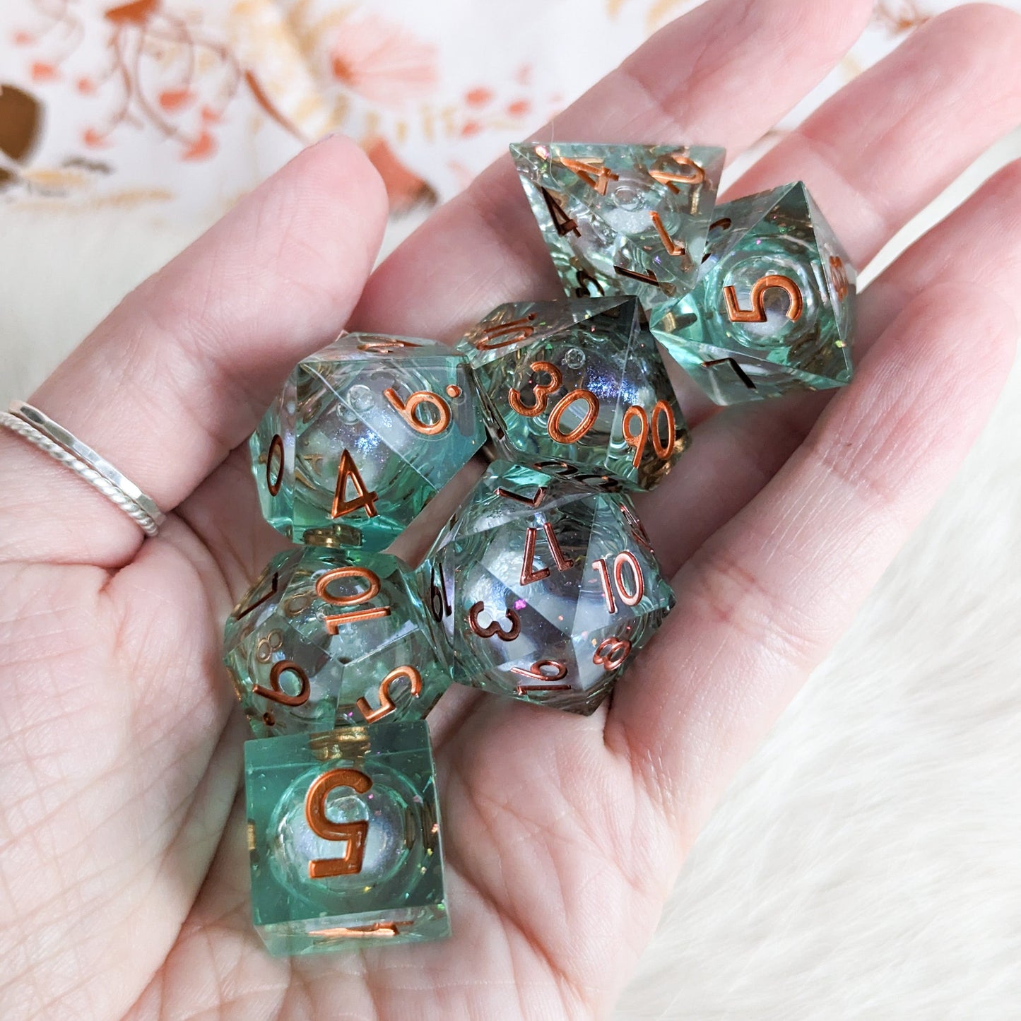 Seafoam Liquid Core Resin DnD Dice Set with Copper Numbers in Hand