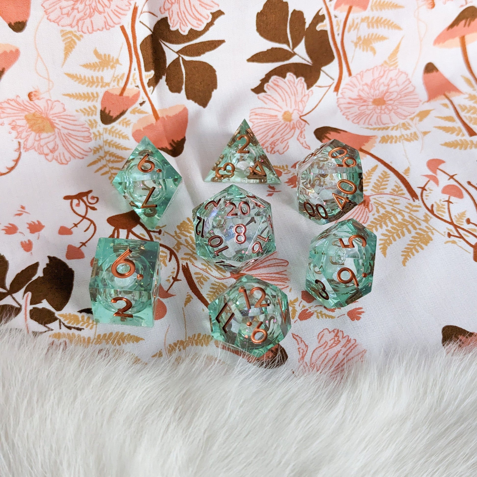 Seafoam Liquid Core Sharp Edge DnD Dice Set on Floral and Fur Background