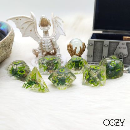 Moss and Lavender 7-Piece Dice Set with Real Plants in Clear Resin for Dungeons and Dragons, Featuring Green Numbers and TTRPG Accessories.