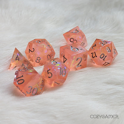 Peach Tea Sharp Edge Resin Dice Set, pink polyhedral dice with holographic details for TTRPG, on a soft white background.