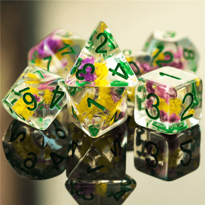 Purple and yellow flower dice set in clear resin, perfect for tabletop RPGs like Dungeons and Dragons, polyhedral 7-piece set.