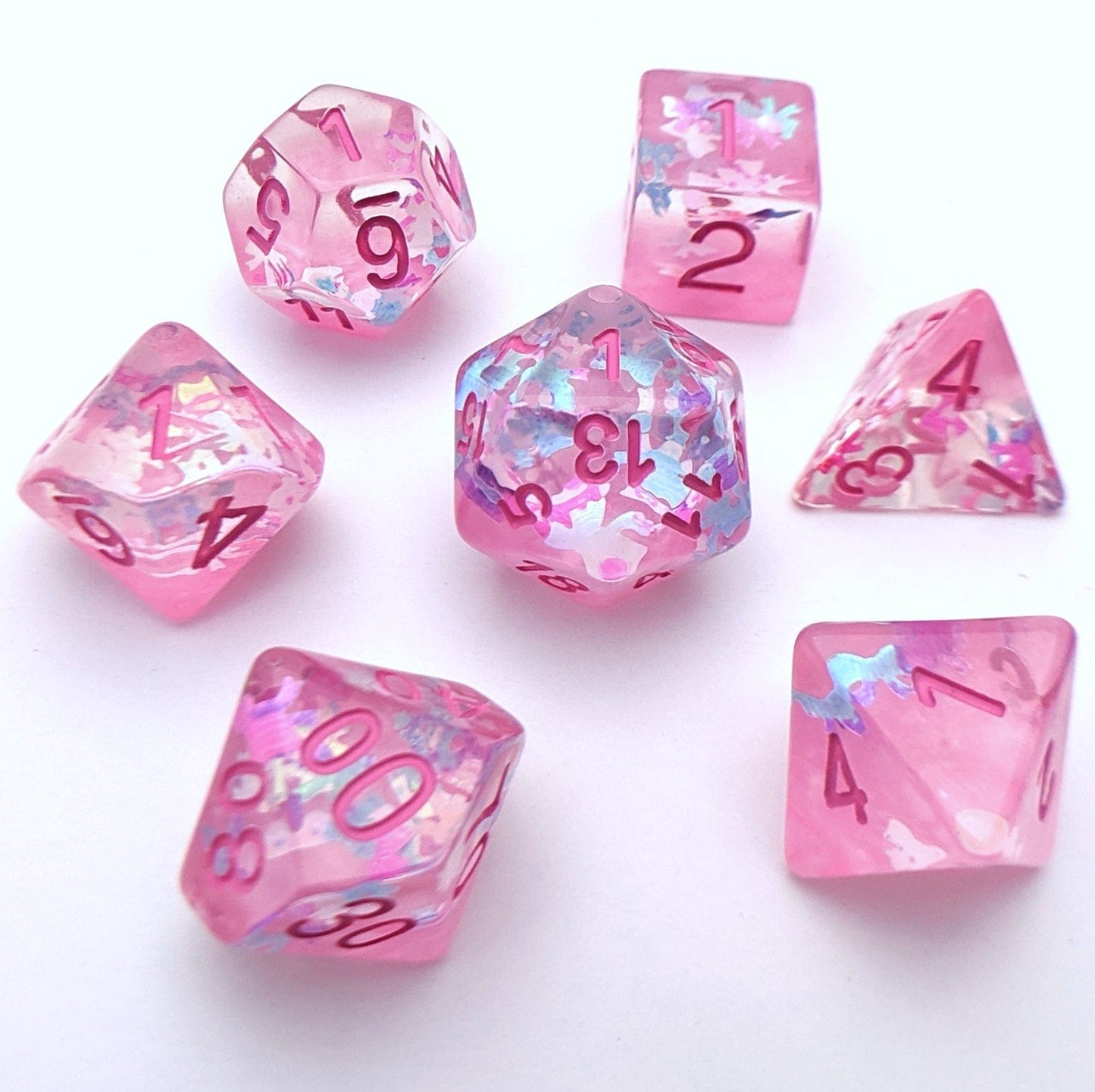 Ribbons and Bows DnD dice set with translucent pearly pink and iridescent ribbon bow glitters, standard 7-piece RPG dice set.