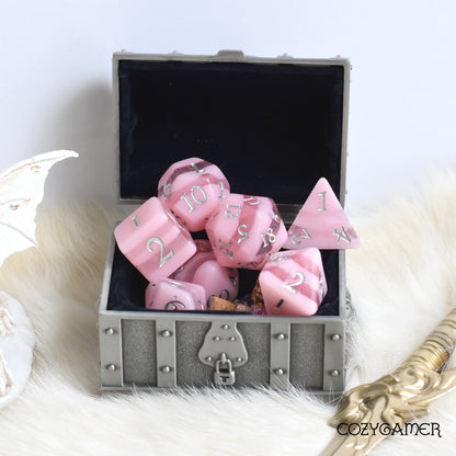 Pastel pink Rose Candies polyhedral dice set with custom font in a treasure box for Dungeons and Dragons and other TTRPGs.