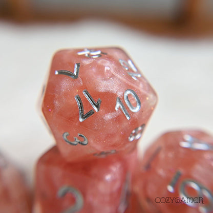 Rose Zephyr 8 Piece Dice Set. Clear resin with pearly pink clouds, glitter, and silver font.