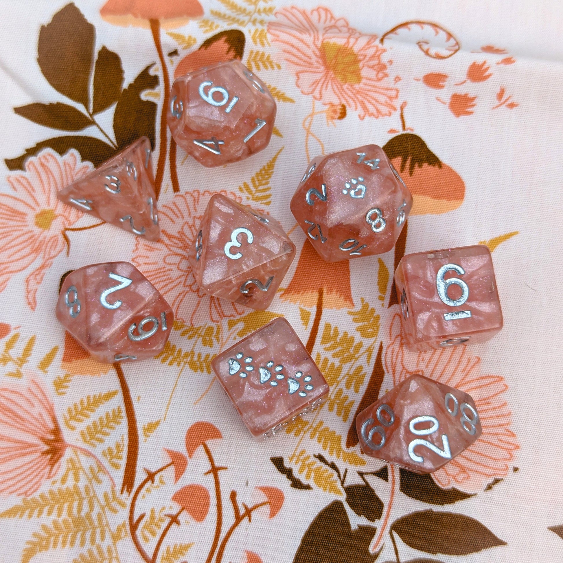 Rose Zephyr 8 Piece Dice Set. Clear resin with pearly pink clouds, glitter, and silver font.