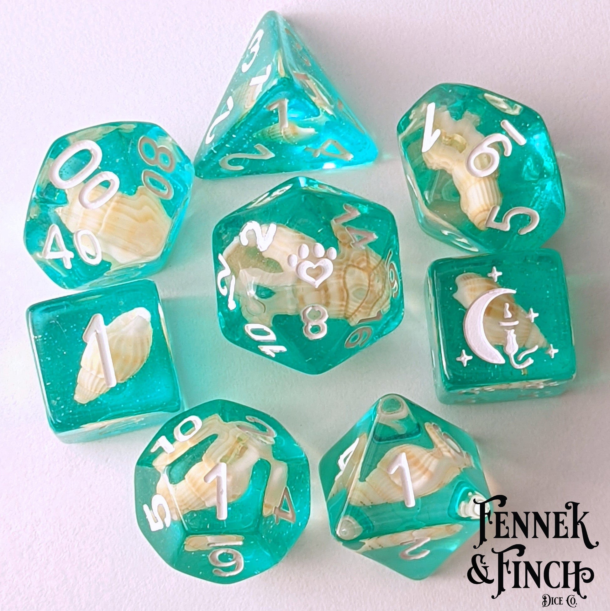 Sea Shell DnD Dice Set with teal glitter resin, featuring real shells, cat wizard, stars, and paw counters for tabletop RPGs.