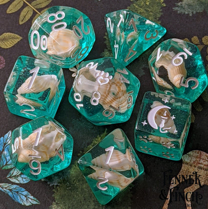 Sea Shell 8 Piece DnD Dice Set with teal resin, real shells, white numbers, custom cat wizard, and paw heart for tabletop RPGs.