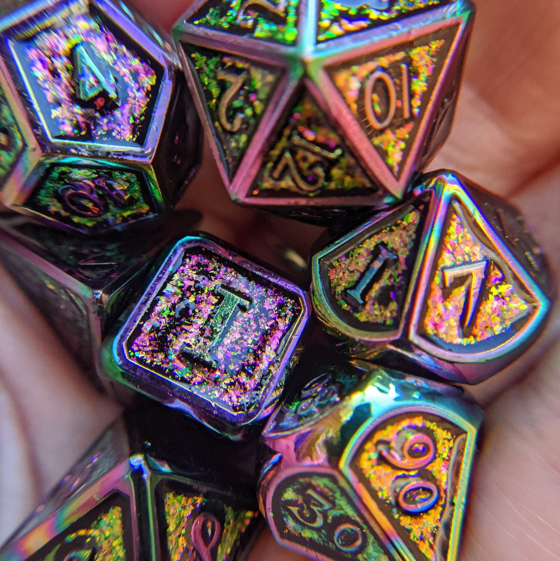 Colorful metal polyhedral dice set with rainbow trim, perfect for Dungeons and Dragons. Featuring glitter details in gold, purple, and green.