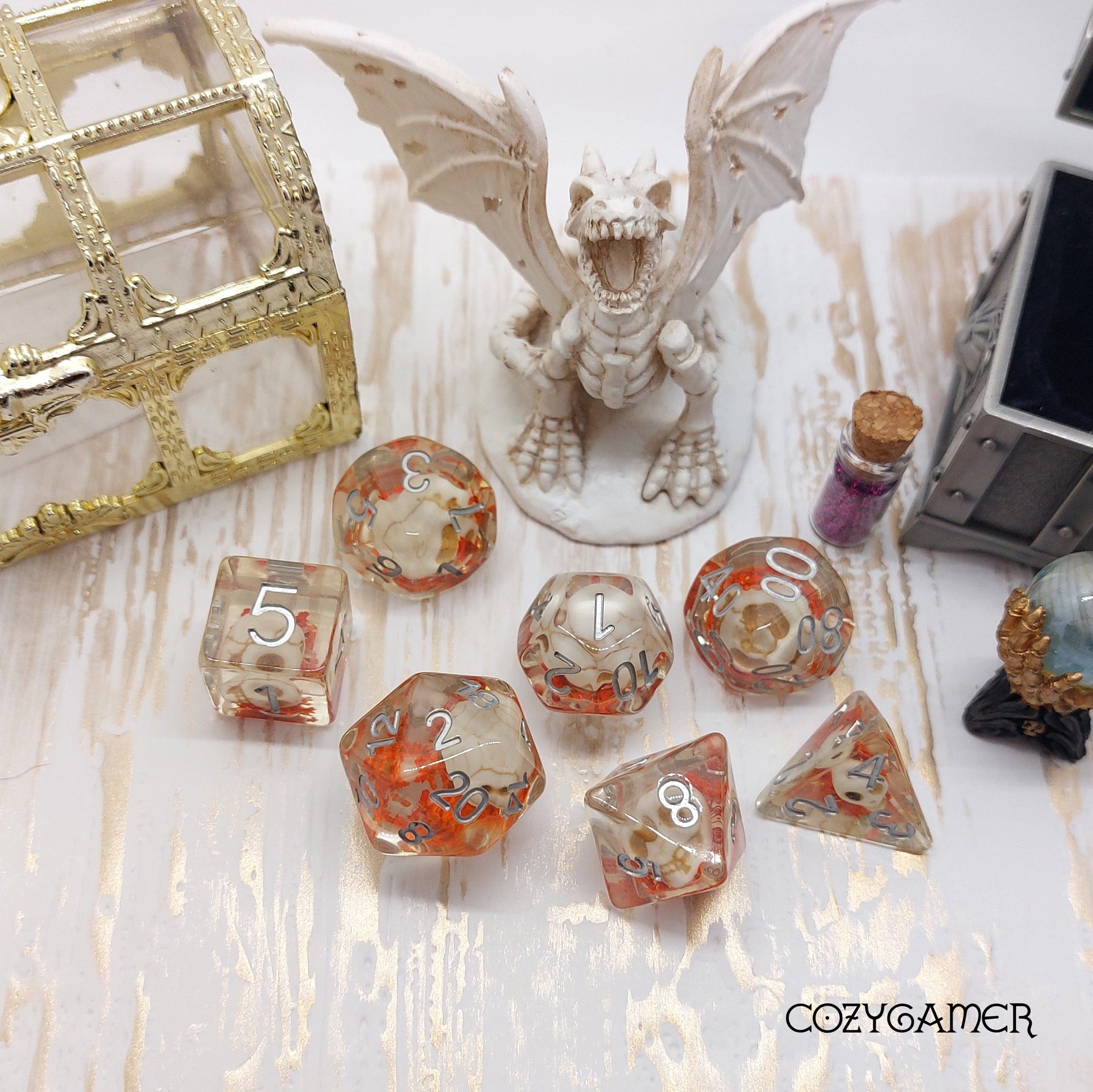 Skullweed polyhedral dice set with skulls and orange flowers, ideal for Dungeons and Dragons, displayed with fantasy decor.