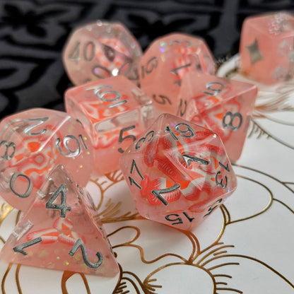 Strawberry Dice Set with glitter, featuring fruit slices and custom designs, 8-piece polyhedral set on floral background.