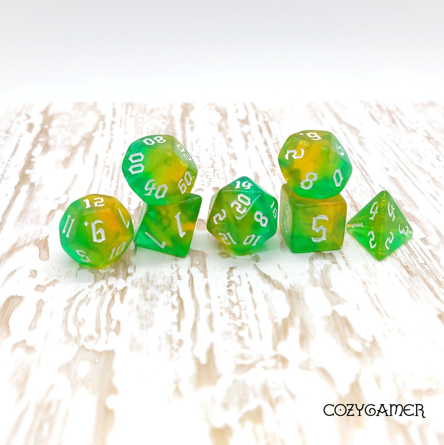 Verdant Oasis Dice Set with marbled green and yellow shimmer, 7 polyhedral pieces for DnD and tabletop RPGs.