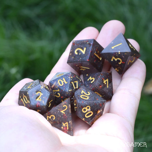 Volcanic Ash Sharp Edge Dice Set. Grey shimmering glitter and red flakes