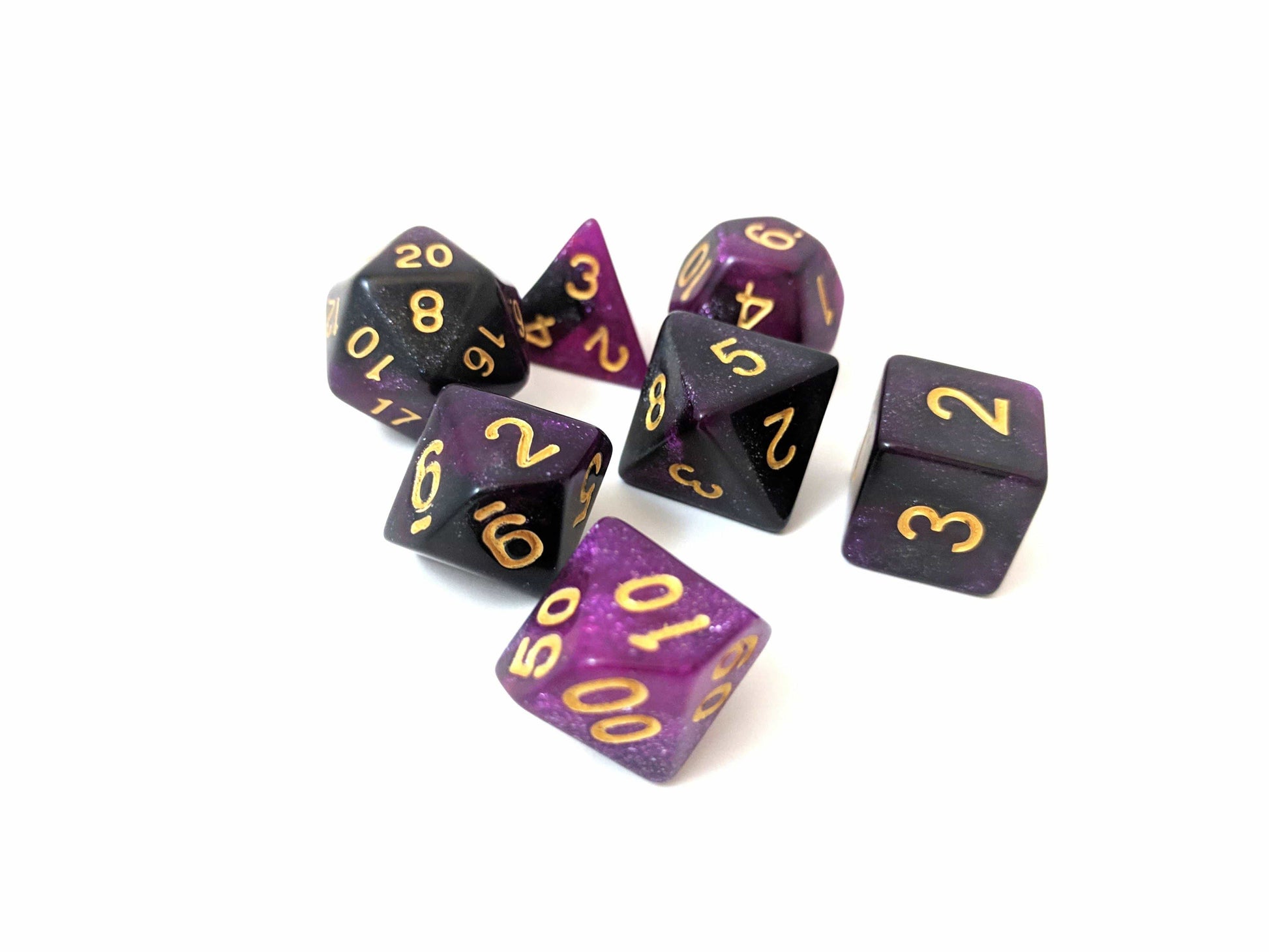 Black and purple Warlock dice set with gold numbers on a white background, ideal for Dungeons and Dragons and tabletop games.