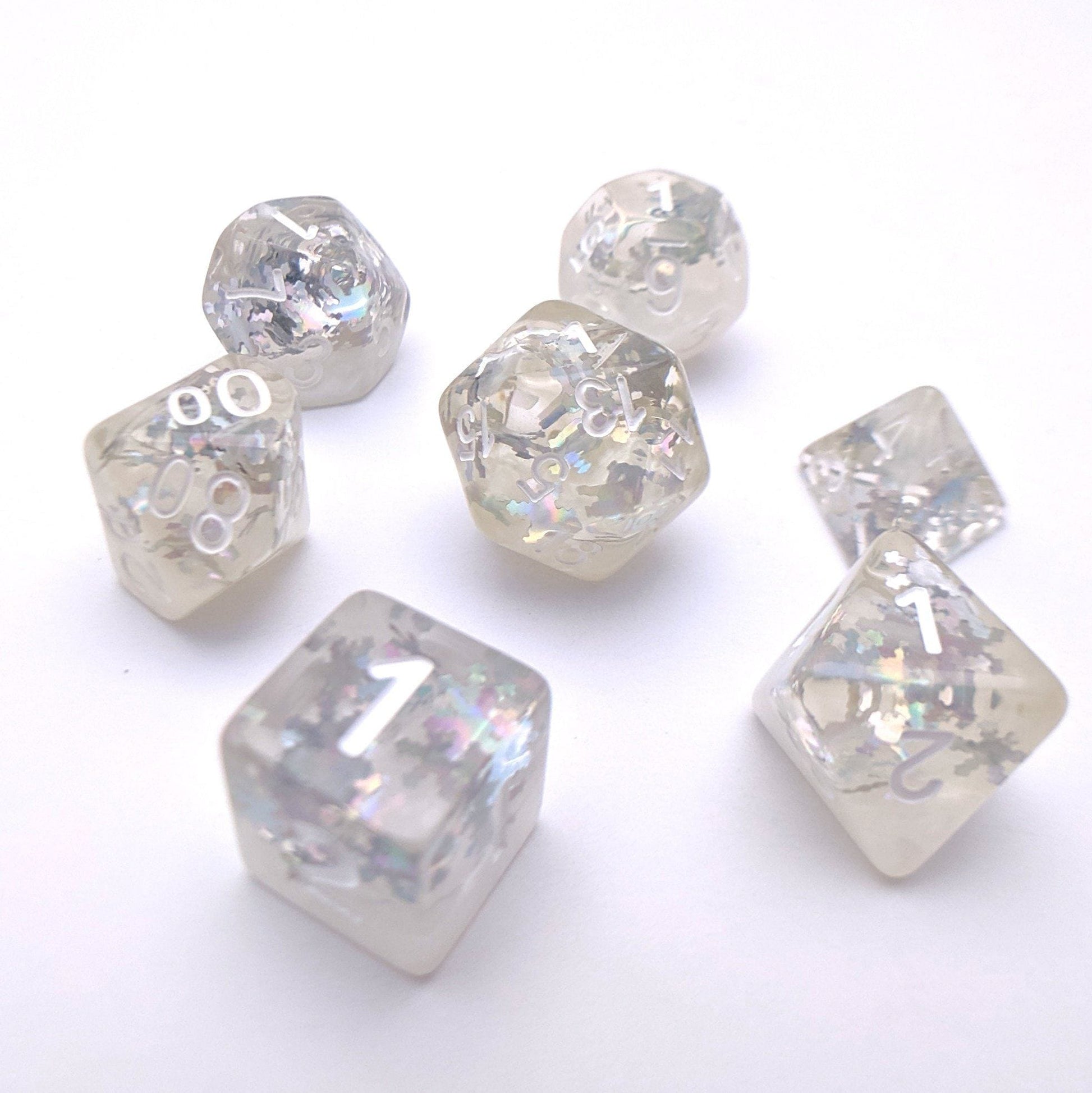 Winter DnD dice set with holographic silver snowflake glitters on translucent pieces, creating a magical snowy effect.