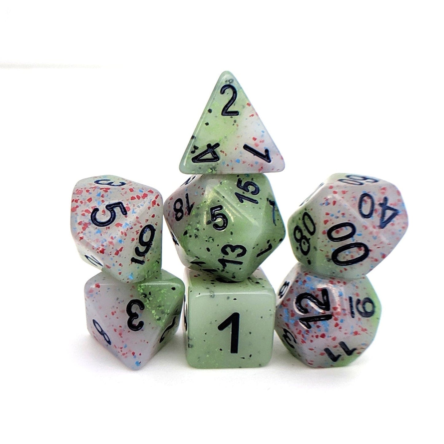 Witch's Robe pastel dice set, featuring purple and green layers with colorful speckles and deep blue numbers, full 7-piece set.